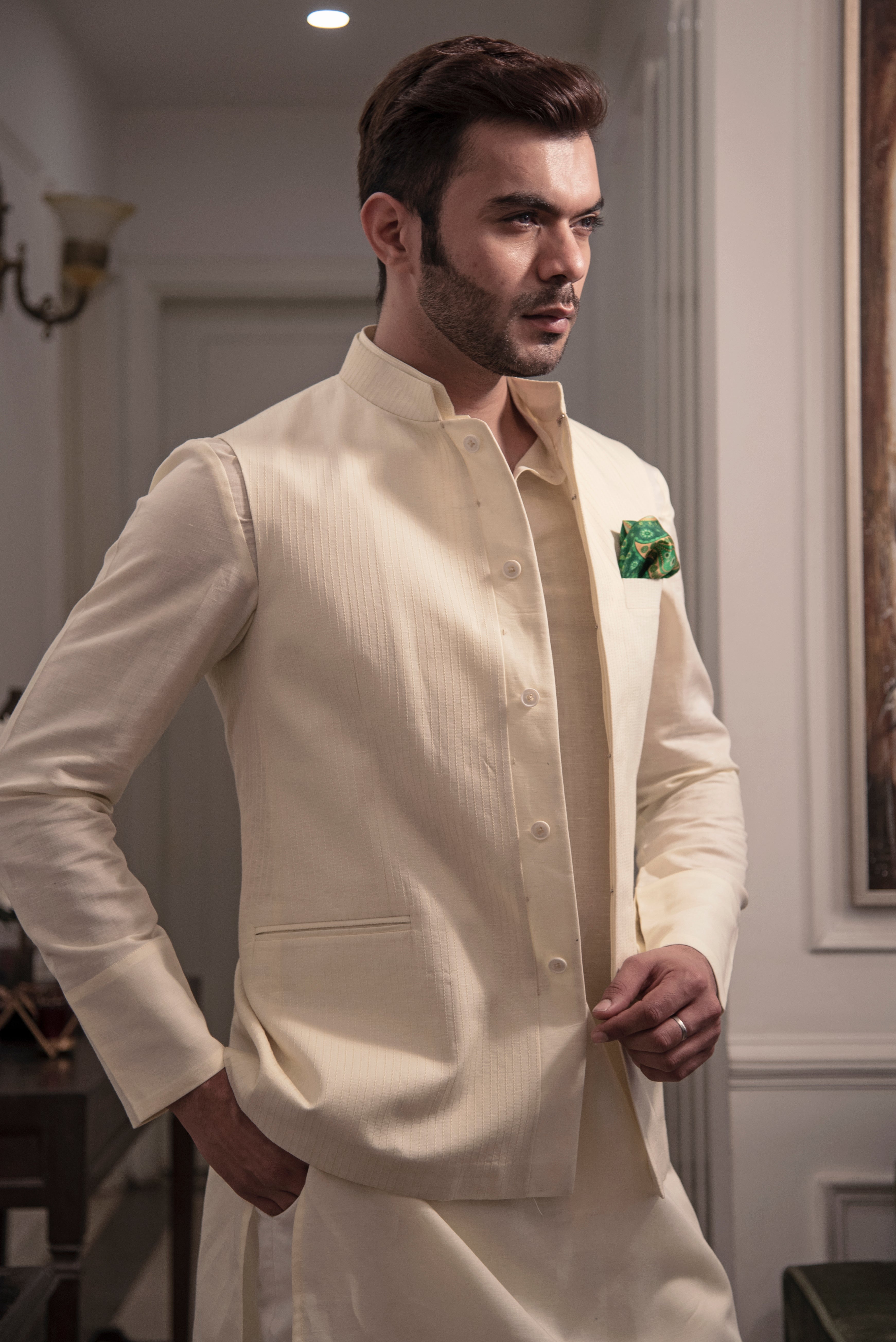 Cream coloured nehru jacket with cream coloured kurta and off white pant pajama.