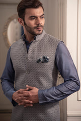 Grey embroidered nehru jacket paired up with blueish grey kurta and off white pajama.