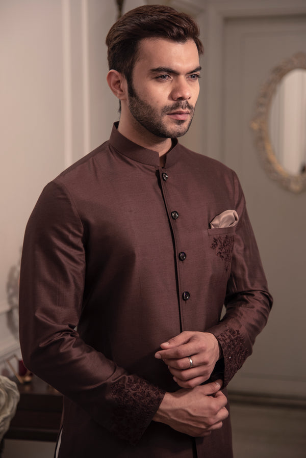 Brown sherwani cut kurta with self coloured embroidery on pocket and cuffs.