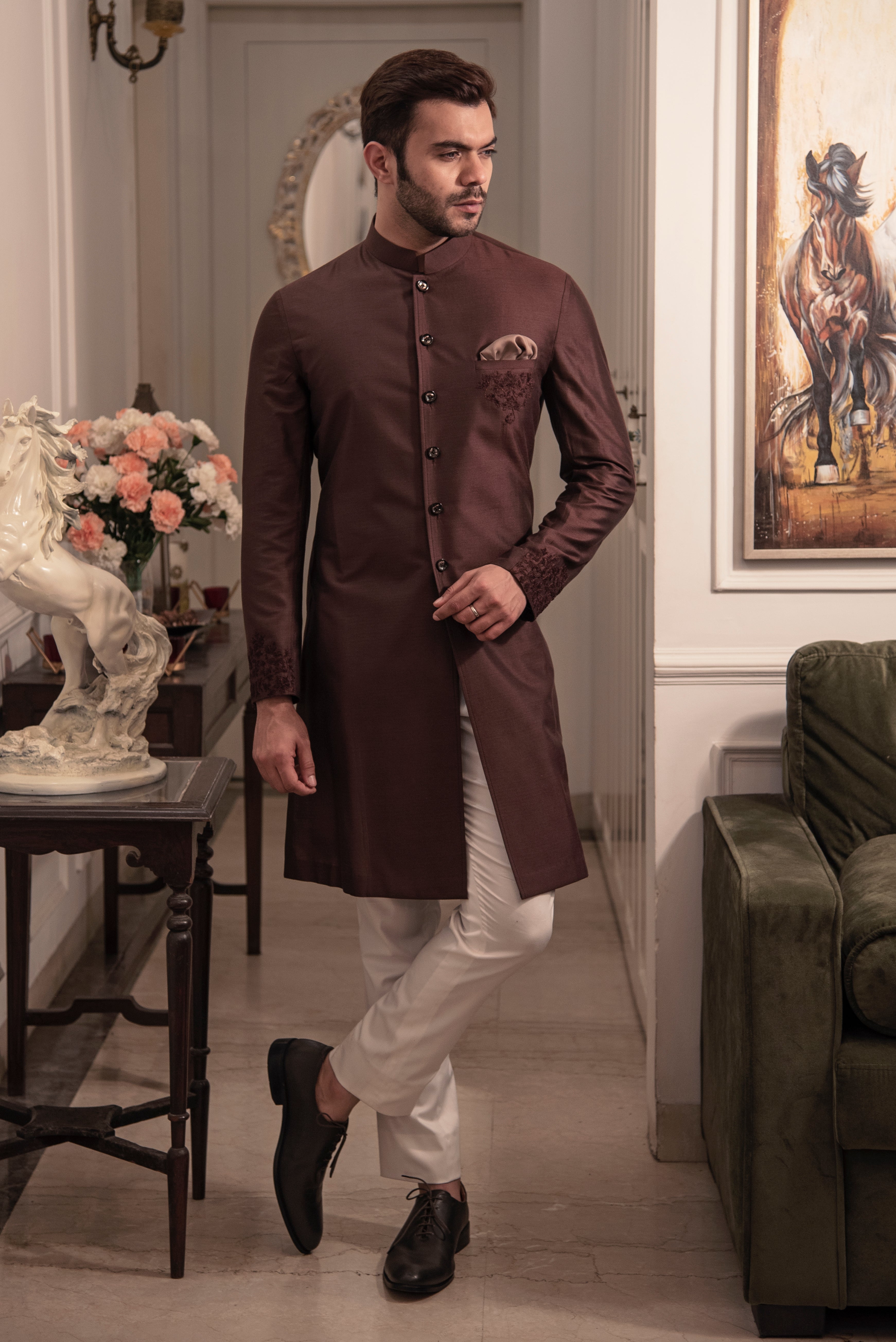 Brown sherwani cut kurta with self coloured embroidery on pocket and cuffs.