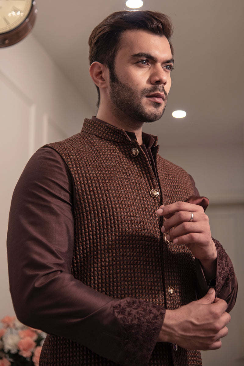 Brown quilted nehru jacket paired up with chocolate brown kurta and off white pajama.