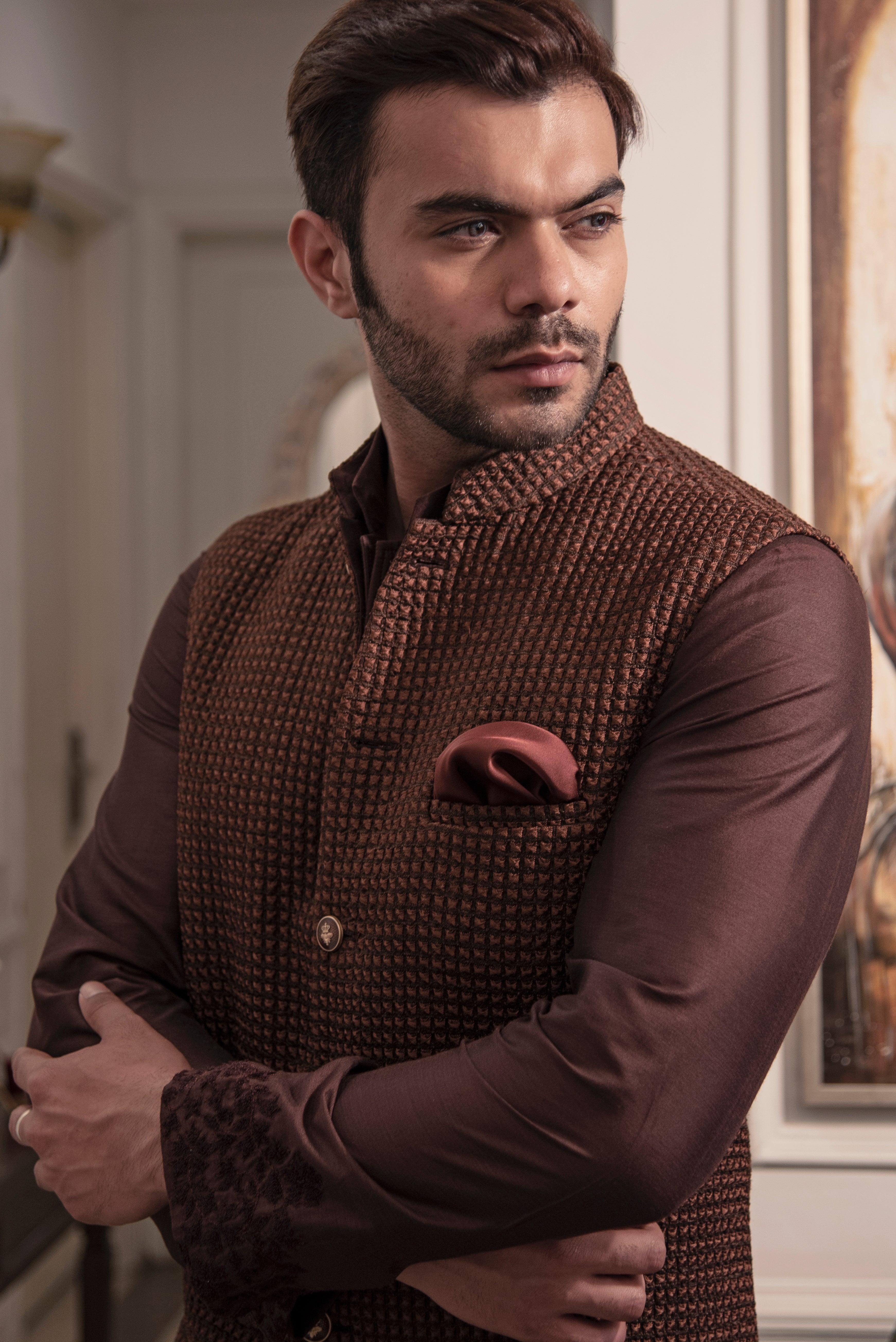 Brown quilted nehru jacket paired up with chocolate brown kurta and off white pajama.