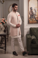 Powder pink fully embroidered long open nehru jacket.  Paired up with off white kurta pajama.