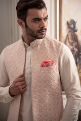 Powder pink fully embroidered long open nehru jacket.  Paired up with off white kurta pajama.