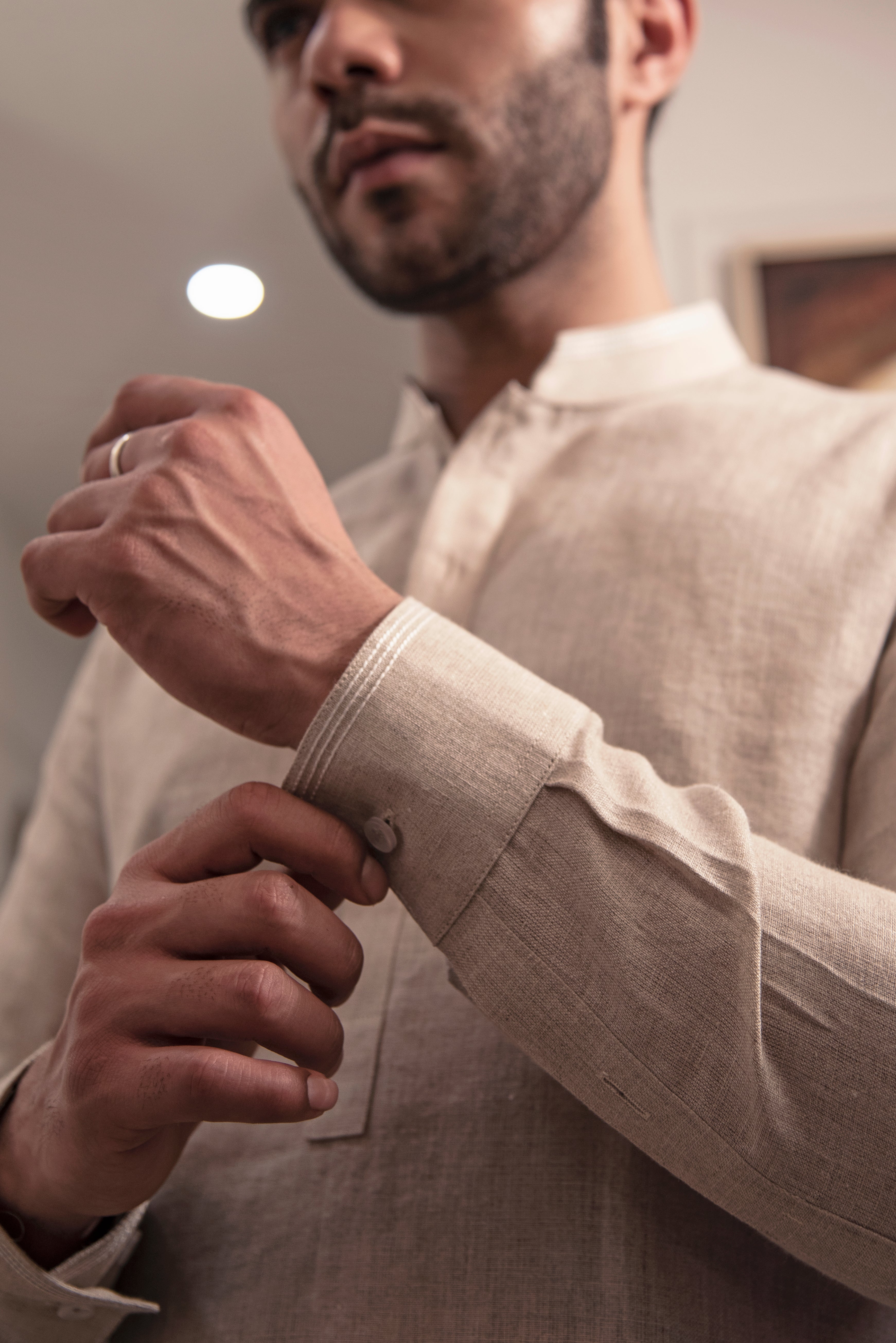 Beige linen kurta with ivory pants.