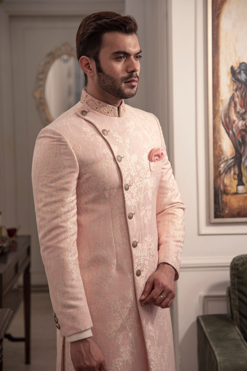Peach coloured asymmetrical cut achkan.