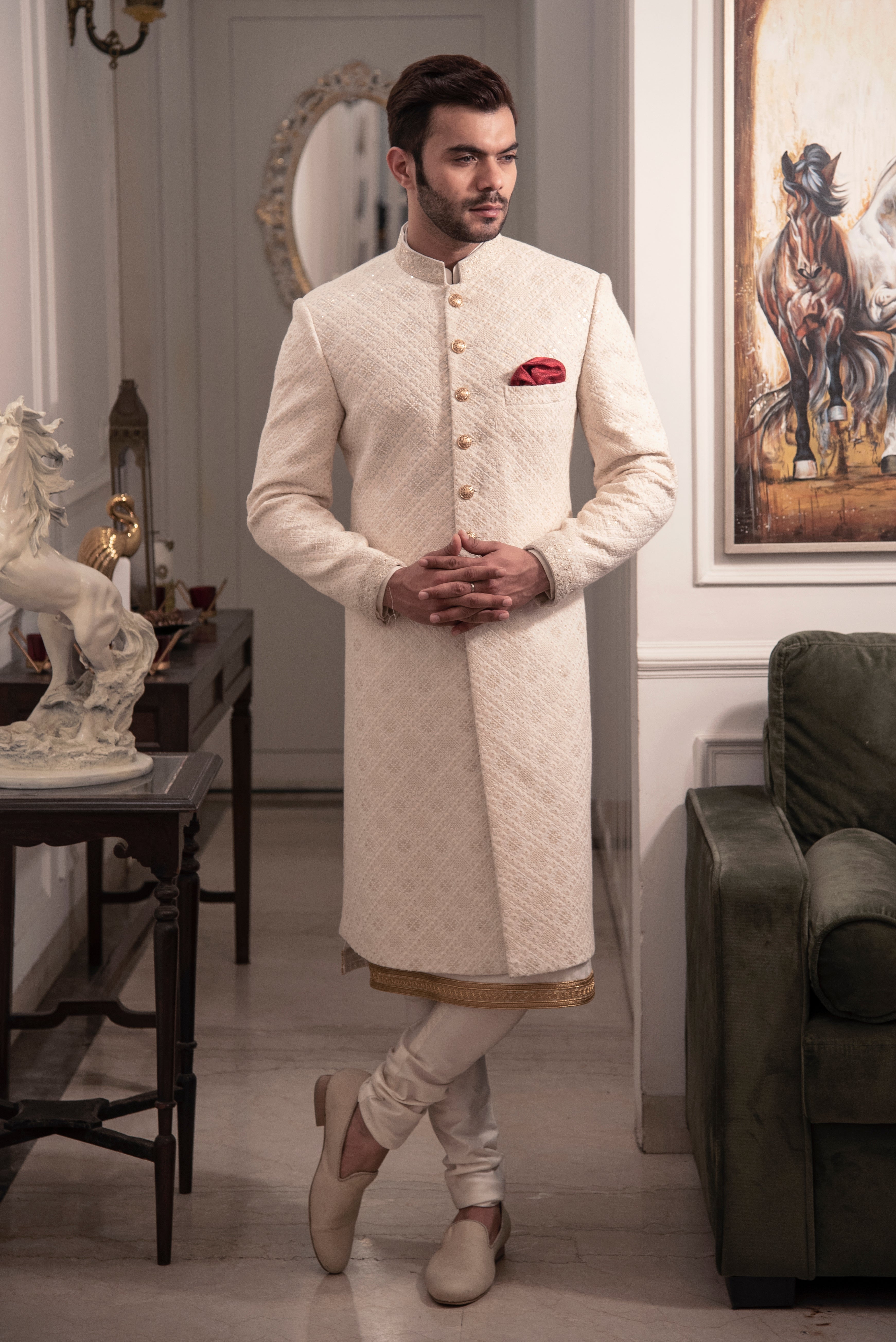 Ivory embroidered sherwani with ivory and gold kurta pajama.