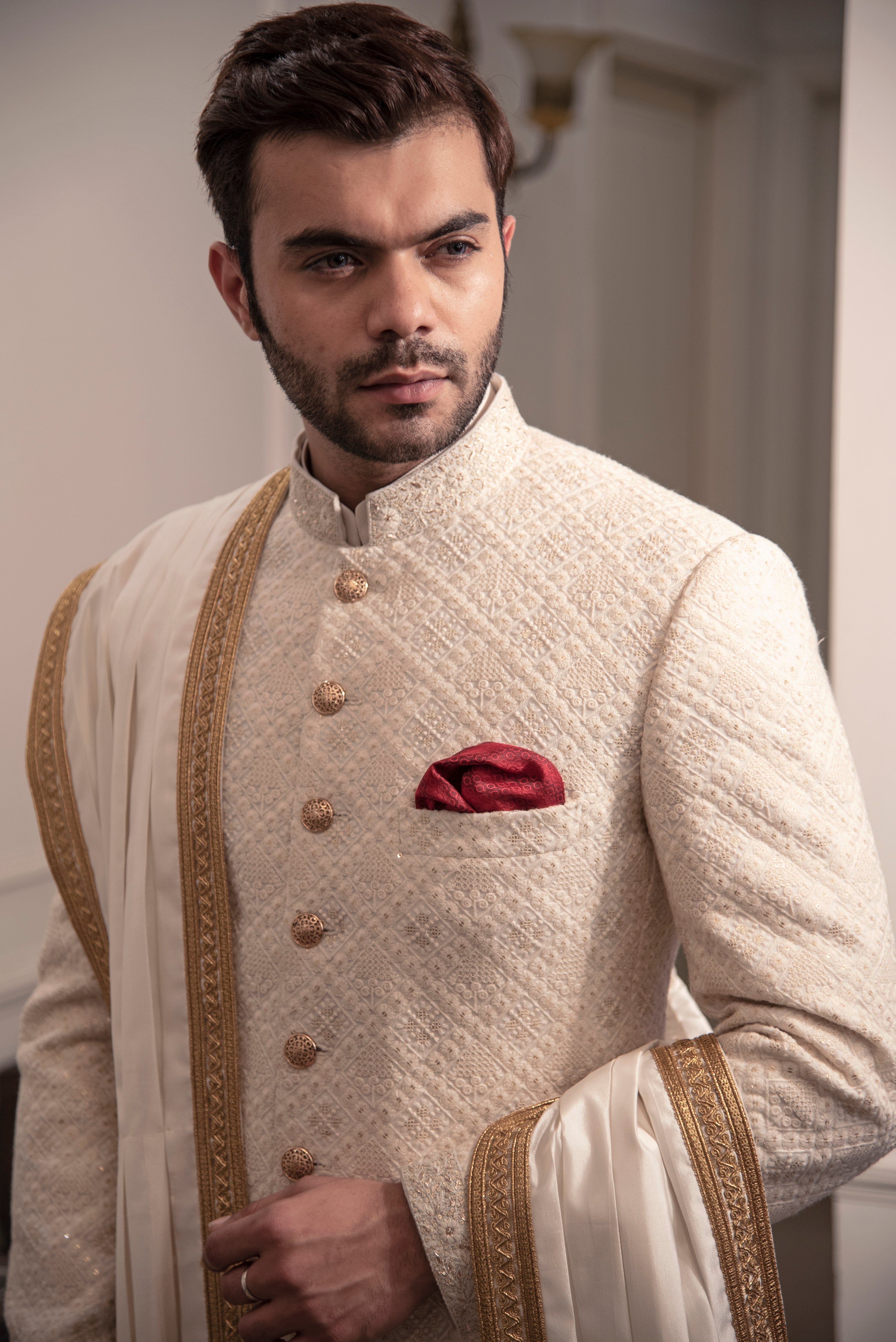 Ivory embroidered sherwani with ivory and gold kurta pajama.