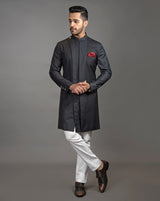 Black asymmetrical sherwani cut kurta with concealed buttons.  Paired up with off white pant cut pajama.